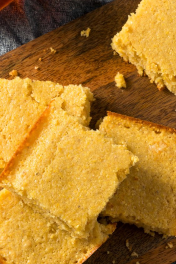 Moist golden honey cornbread with a tender crumb and lightly crisp edges, sliced and ready to serve.