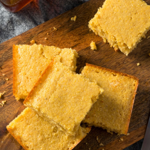 Moist golden honey cornbread with a tender crumb and lightly crisp edges, sliced and ready to serve.