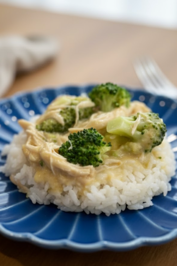 Instant Pot creamy chicken and broccoli over rice on a plate.