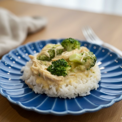 Instant Pot creamy chicken and broccoli over rice on a plate.