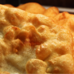 A plate of gold Indian fry bread, fried to perfection and crispy.