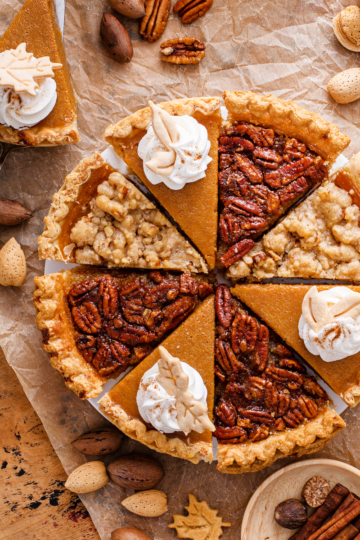 A variety of sliced pies on a rustic wooden table, showing how much pie to serve per person for gatherings and holidays.