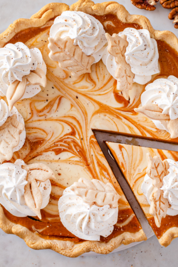 Freshly baked pie cut into even slices on a pie plate, showing clean wedges ready to serve at a gathering.