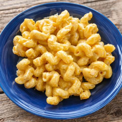 Smoked gouda mac and cheese in a blue bowl on rustic wooden table