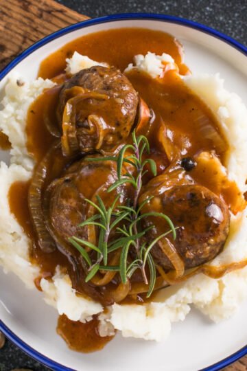 Creamy homemade sourdough discard gravy served warm in a skillet, smooth and rich with a classic peppered finish.