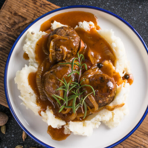 Creamy homemade sourdough discard gravy served warm in a skillet, smooth and rich with a classic peppered finish.