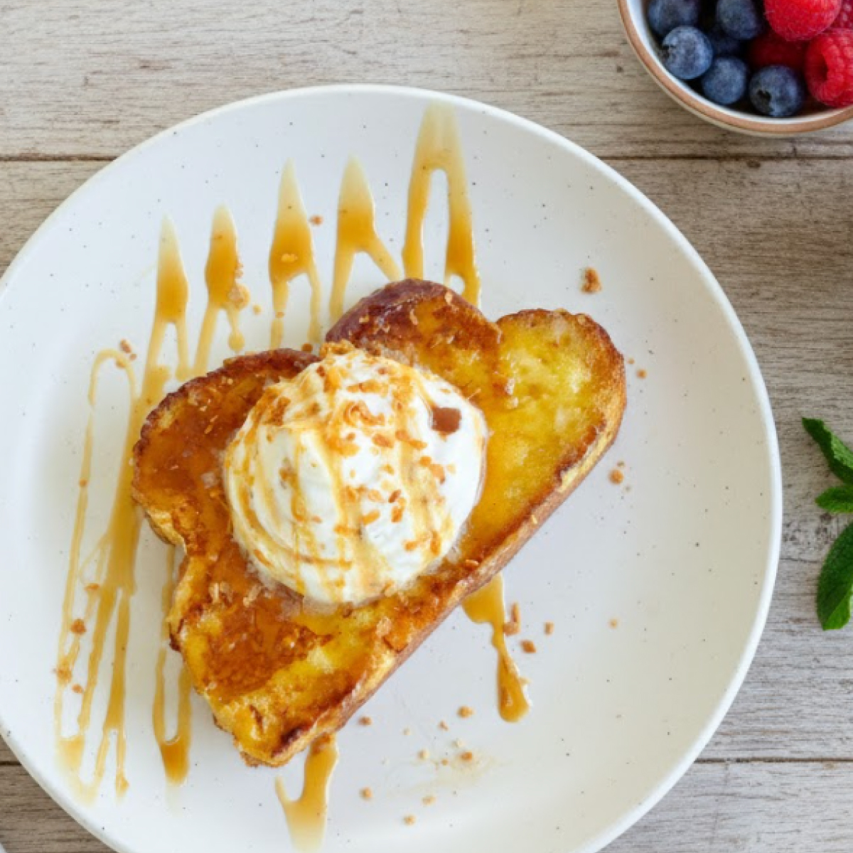 Dreamy coconut cream pie French toast topped with whipped cream and toasted coconut.