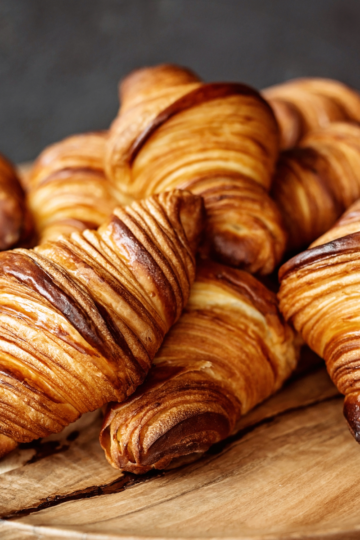 Contrasting blocks of lamination butter: one cracked from freezing and one smooth and pliable, illustrating the negative effect of freezing on butter quality for croissant dough.