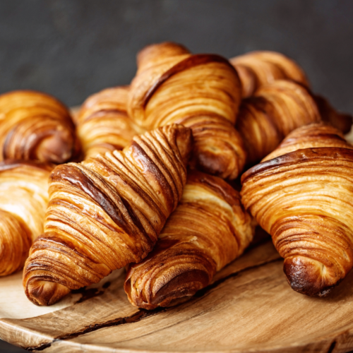Contrasting blocks of lamination butter: one cracked from freezing and one smooth and pliable, illustrating the negative effect of freezing on butter quality for croissant dough.
