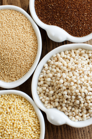 Flat-lay of gluten-free pantry staples including grains, beans, and baking essentials arranged on a kitchen counter.