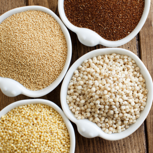 Flat-lay of gluten-free pantry staples including grains, beans, and baking essentials arranged on a kitchen counter.