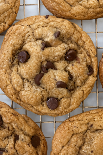 A cookie rack filled with soft and chewy chocolate chip cookies.