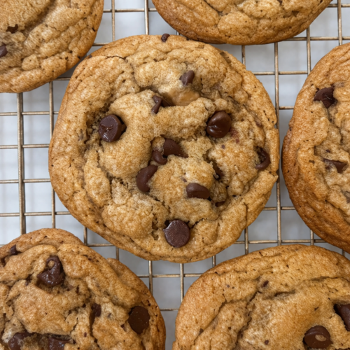 A cookie rack filled with soft and chewy chocolate chip cookies.