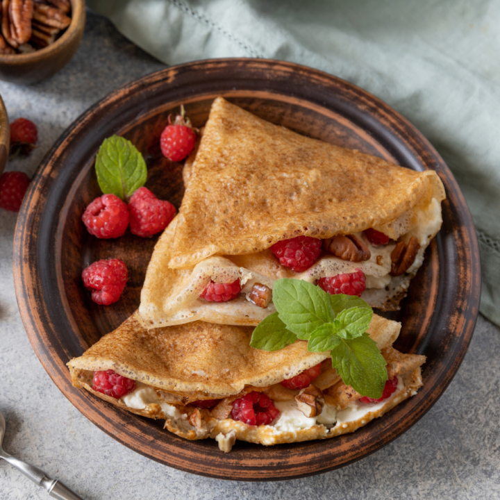Sourdough crepes filled with fresh colorful fruit and fluffy cream.