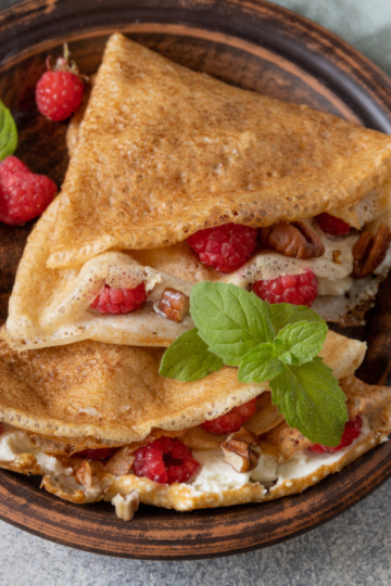 Sourdough crepes filled with fresh colorful fruit and fluffy cream.