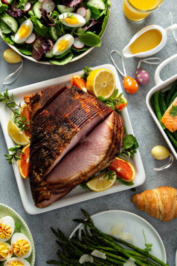 A beautifully set easter buffet table with ham, salad and perfectly cooked sides.