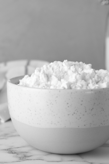 A nice ceramic bowl filled with cornstarch sitting on a nice marble countertop.