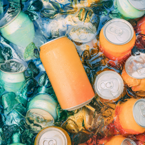 Ice-filled cooler packed with chilled sparkling water cans at a summer party.