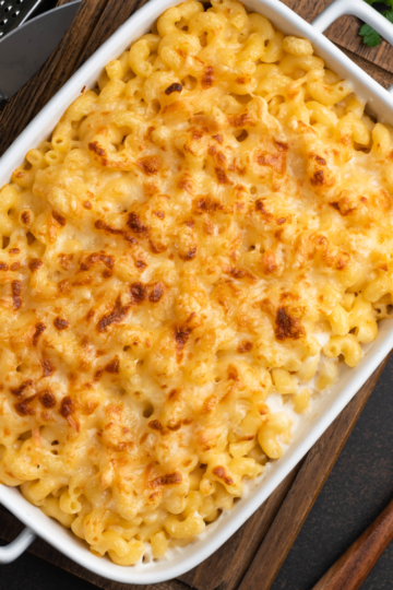 Top-down view of a 9x13 pan of homemade baked mac and cheese with golden bubbly topping.